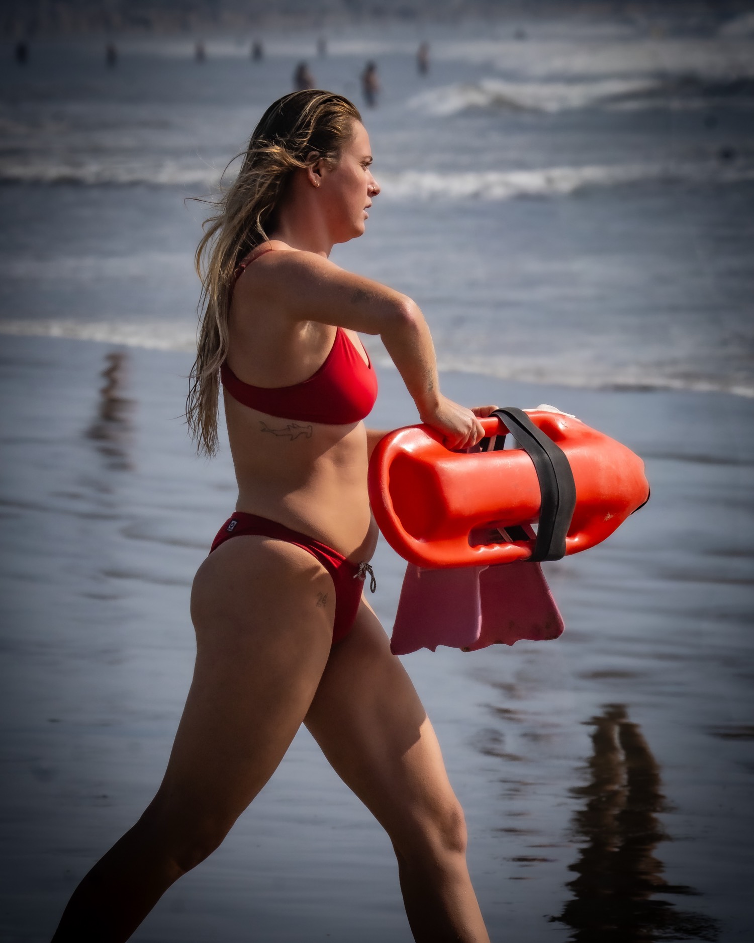 Lifeguard running with a rescue can