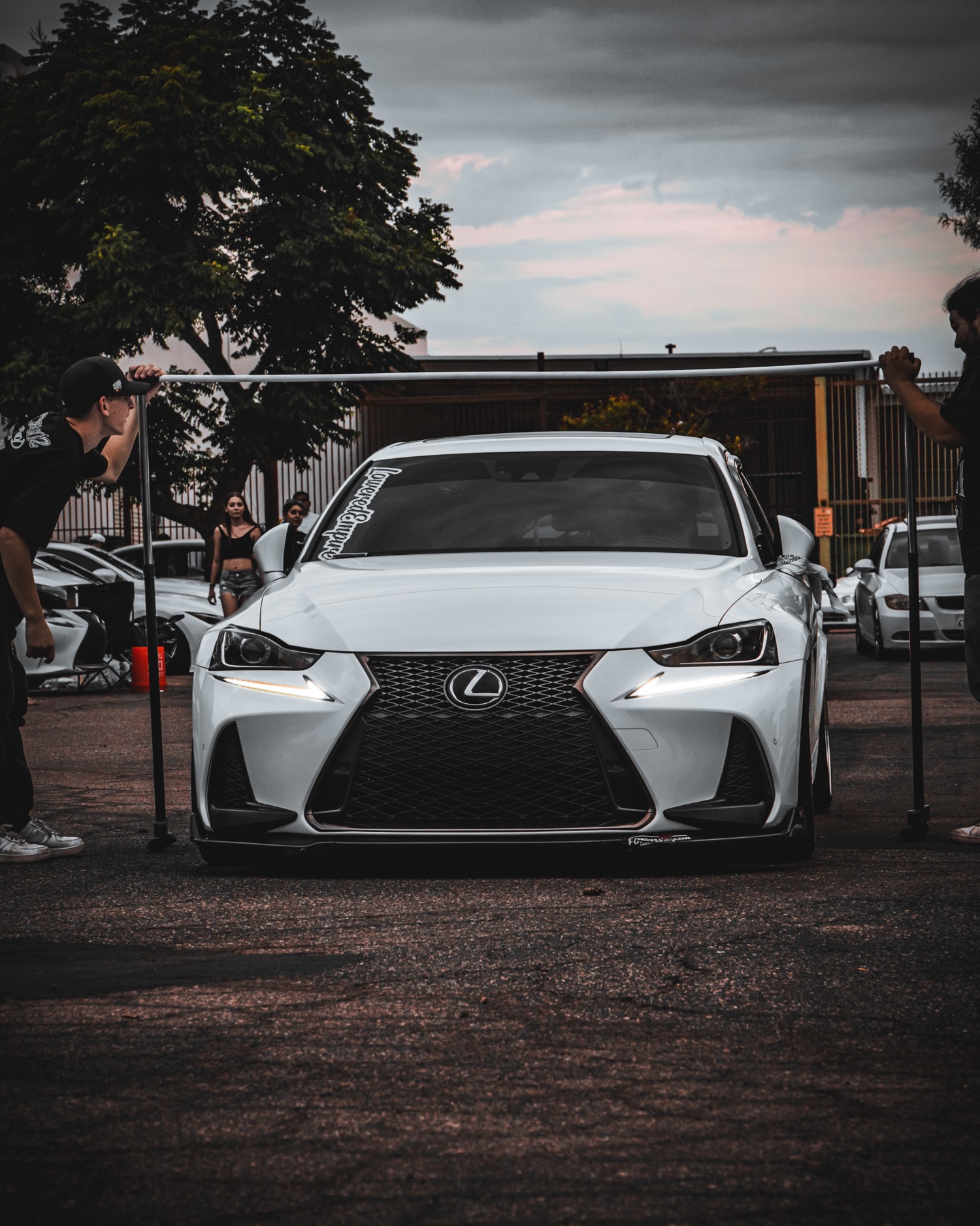 White Lexus under a height stick