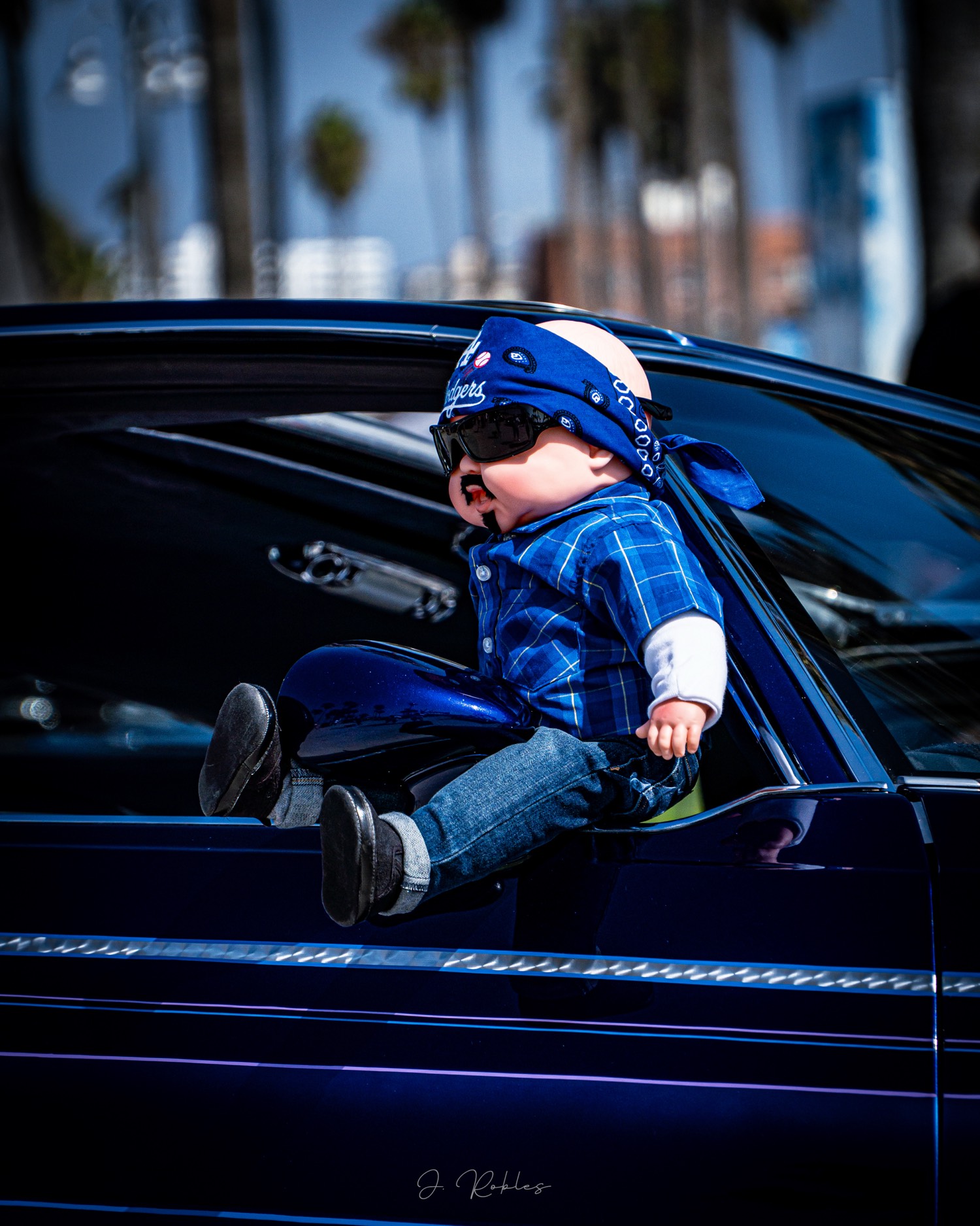 Doll in the window of a lowrider
