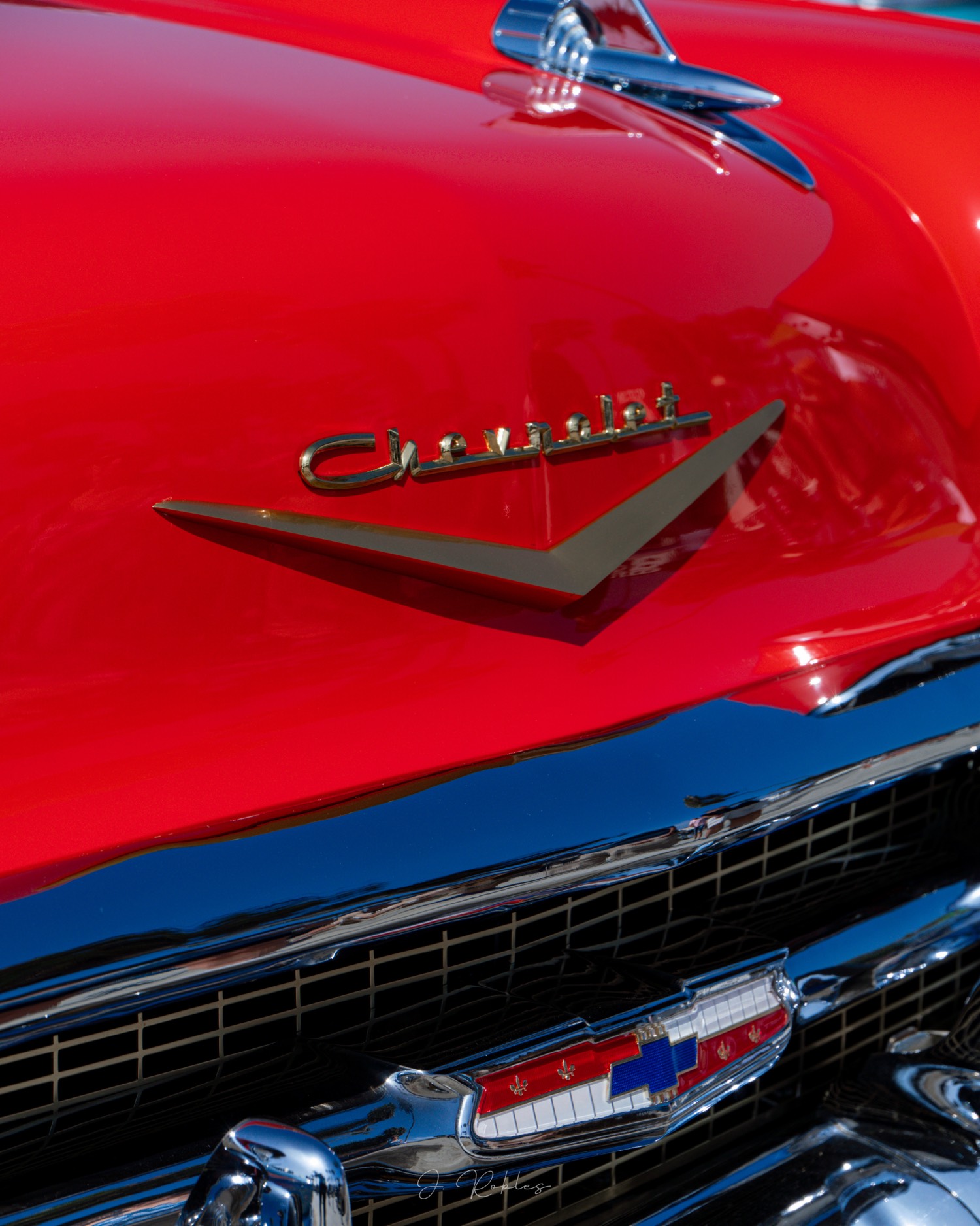 Chevrolet script on red hood