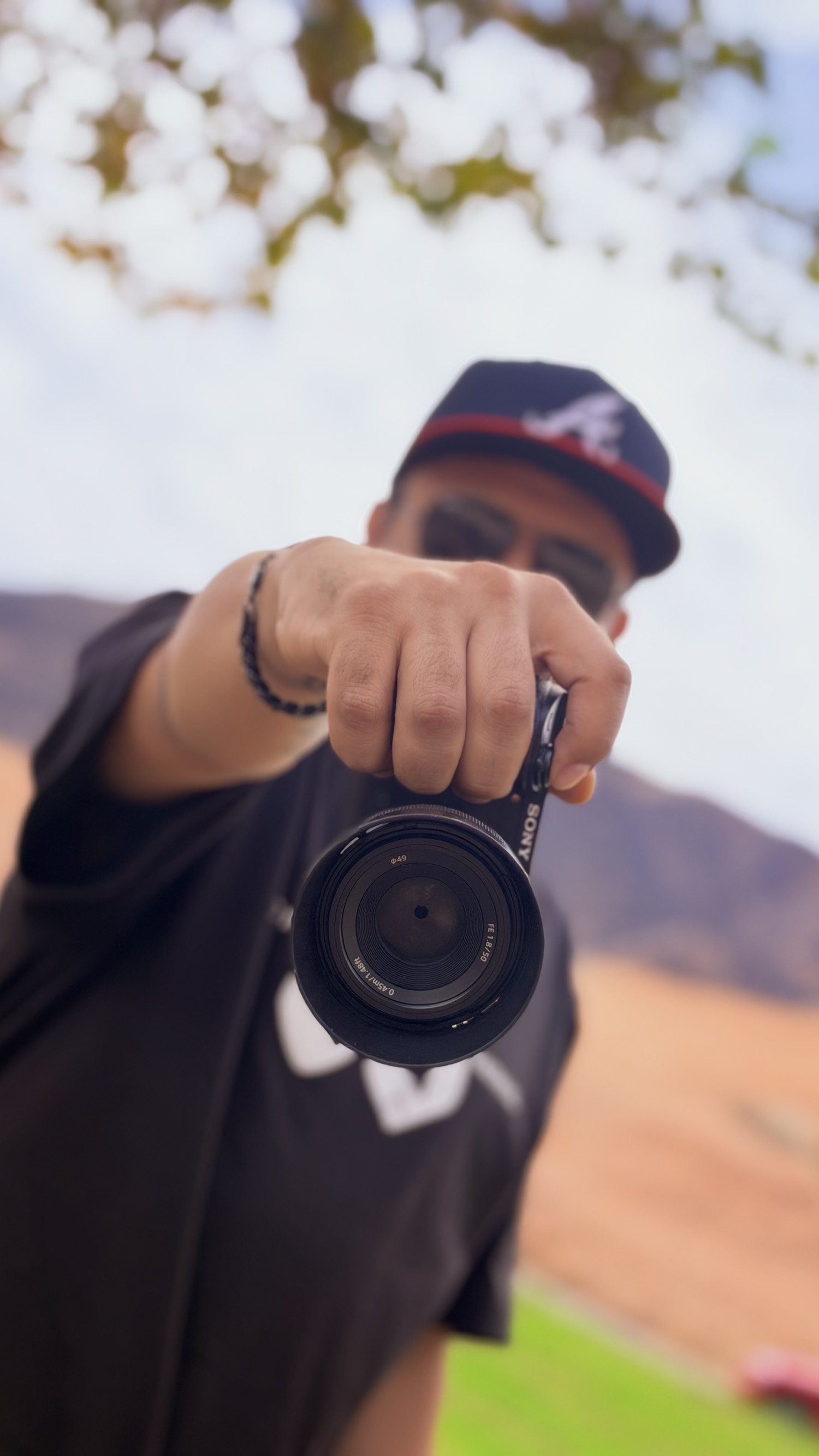 Photographer holding a camera toward the lens